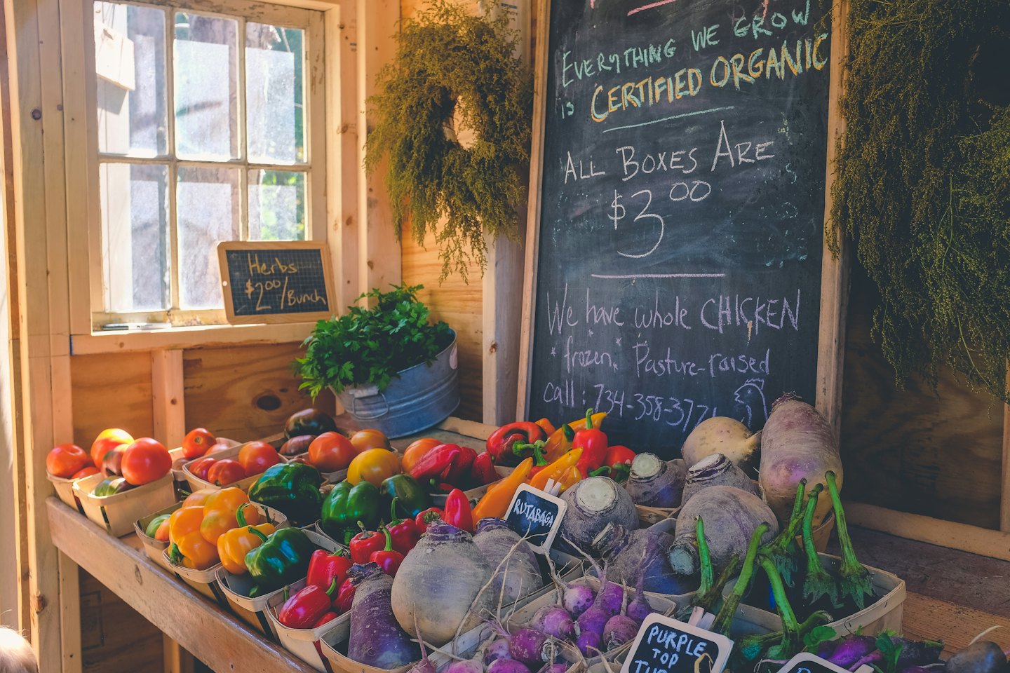 Rustic farm stand overflowing with organic vegetables and herbs.